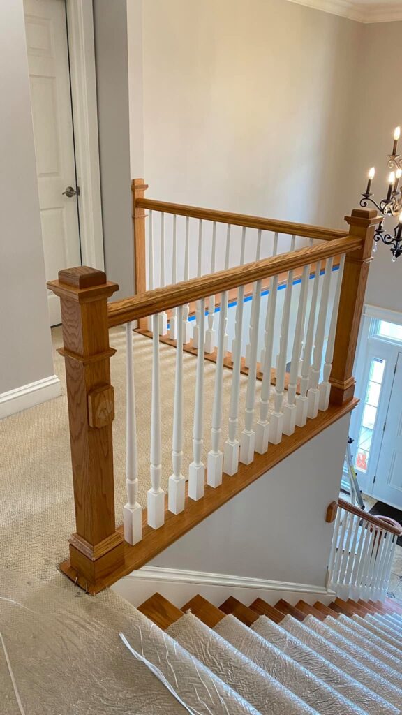 Staircase with fresh paint and wood trim by Franc Painting in Akron, Ohio.