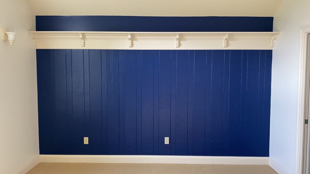 Blue accent wall with white trim in a living room by Franc Painting in Akron, Ohio.