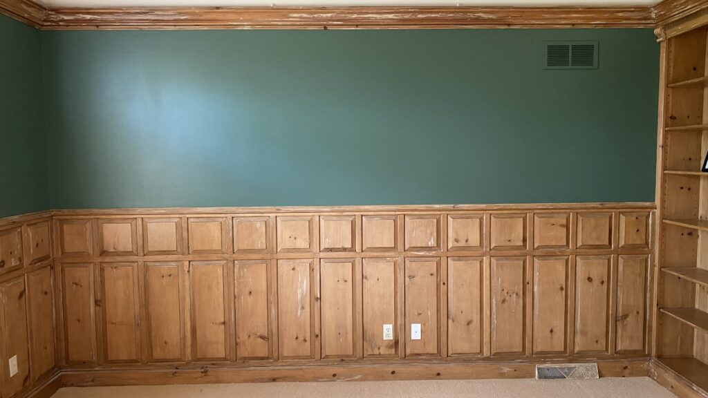 Green painted wall with wood paneling in a study or library by Franc Painting in Akron, OH.