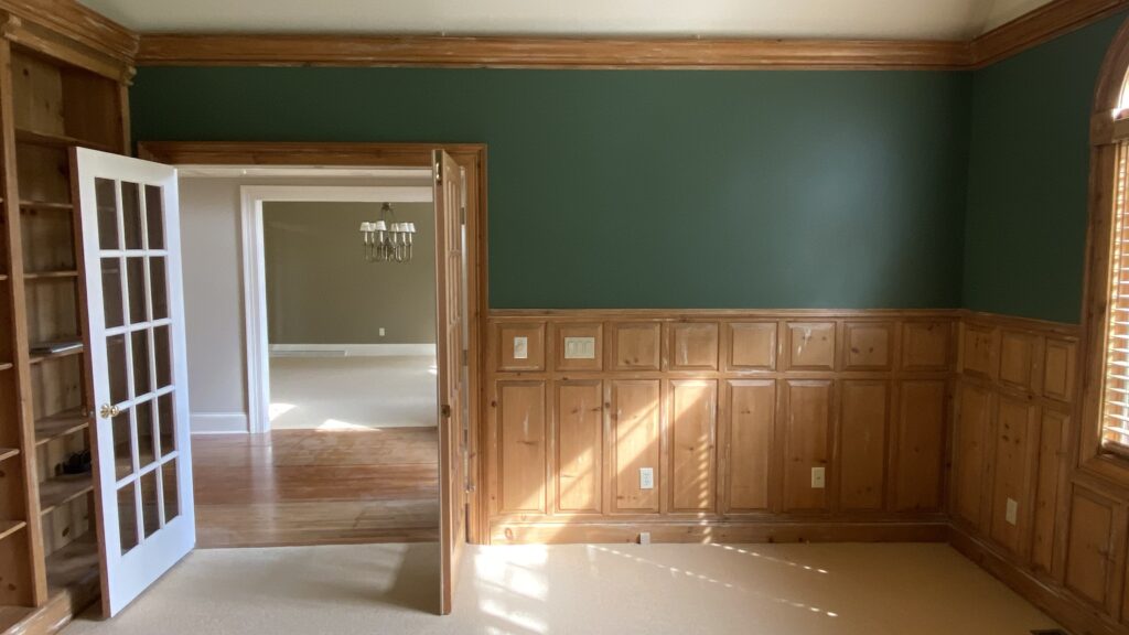 Library room with green wall and built-in wood shelving painted by Franc Painting in Akron, Ohio.