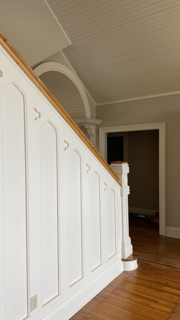 Hallway with soft yellow walls and white trim by Franc Painting.