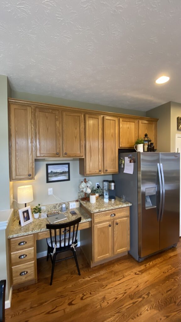 Kitchen workspace with painted walls and wood cabinets by Franc Painting in Akron, Ohio.