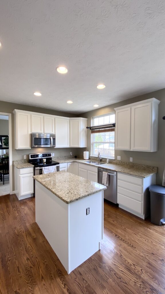 Bright kitchen with white cabinets and freshly painted walls by Franc Painting in Akron, Ohio.