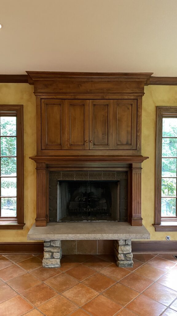 Wooden fireplace mantel in an Akron home, finished by Franc Painting with natural wood tones.