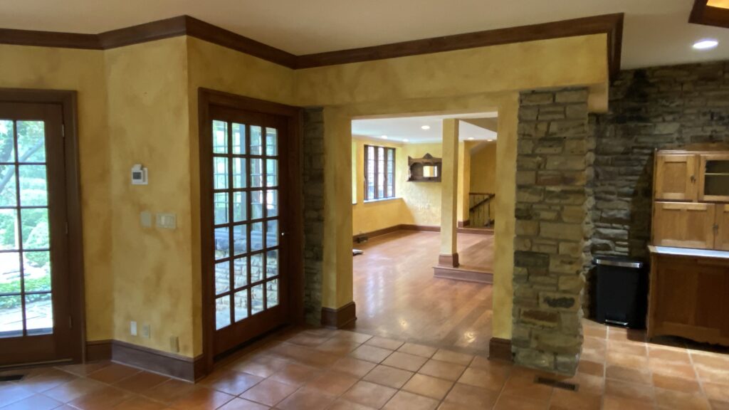 Entryway with textured yellow walls and French doors painted by Franc Painting in Akron, Ohio.
