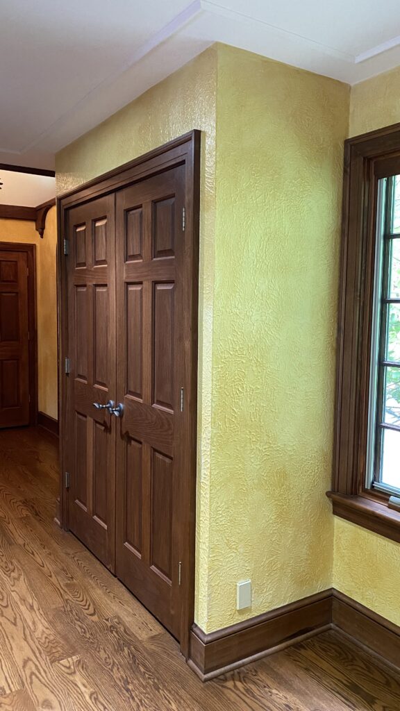 Double closet doors with earth-toned walls painted by Franc Painting in Akron, Ohio.