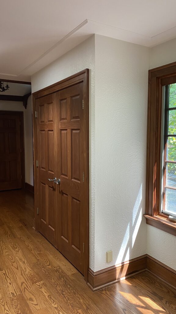 Wooden closet doors with light-colored walls painted by Franc Painting in Akron, Ohio.